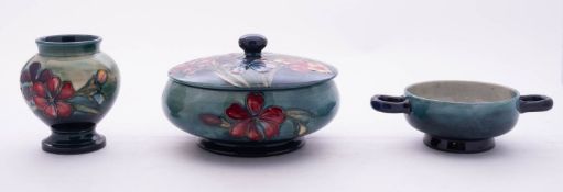 Three pieces of Moorcroft pottery each tube lined in the Spring Flowers pattern on a graduating