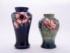 Two William Moorcroft pottery vases both tube lined in the Anemone pattern and both of baluster