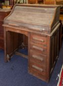 An oak tambourl-top desk, early 20th cen