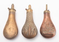 Three pressed metal black powder flasks.