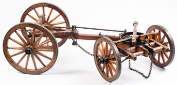 A teak and wrought iron dual axle hand c