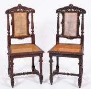 A pair of Victorian oak and canework sid