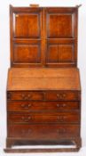 An 18th century oak bureau cabinet, uppe