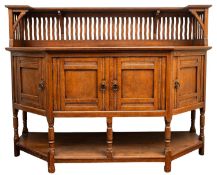 A Liberty & Co arts and crafts oak sideboard, shaped top,
