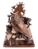 A 'Black Forest' carved and stained linden wood bookslide,