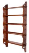 An Edwardian walnut five tier hanging open bookcase, of Aesthetic movement design,