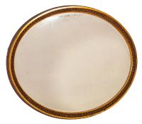 A late 19th Century giltwood oval mirror, the bevelled plate within a reeded frame, 105cm x 84cm.