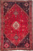 An Irania carpet, the rose hexagonal field with a central ivory stepped hexagonal medallion,