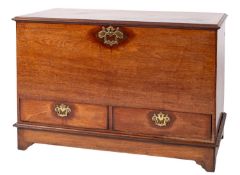 A George III mahogany dower chest, on a low stand, the rectangular hinged top with a moulded edge,