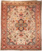 A Tabriz carpet, the ivory field with a central indio shaped pole medallion,