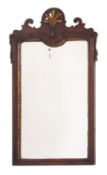 A 19th Century walnut and partly gilt wall mirror, with palmette, tassel and fret cut cresting,