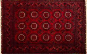 A Turkoman rug, the wine field with three rows of stepped octagons,