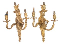 A pair of gilt metal three light wall appliques in Louis XV style,