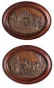 A pair of repoussé worked and patinated copper oval relief panels,