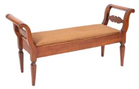 A 19th Century Continental walnut scroll end window seat, having an upholstered slip in seat,