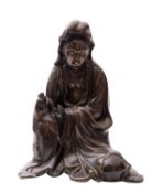 A large Chinese bronze seated figure of Guanyin with downcast eyes and covered head,