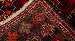 A Turkoman rug, the wine field with an all over design of quartered octagons,