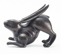 A Japanese bronze study of a hare, Edo period modelled crouching, its long ears along its back,