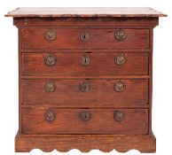 An 18th Century Dutch teak chest, of small size, the overhanging top with a serpentine moulded edge,