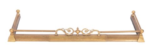A Victorian brass fender, with cresting rail,