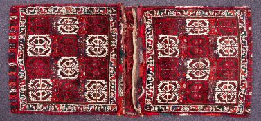 A Turkoman saddle bag, the faces with wine and ivory panels and geometric designs,