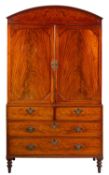 An early 19th Century mahogany linen press, the upper part with boxwood strung lines,