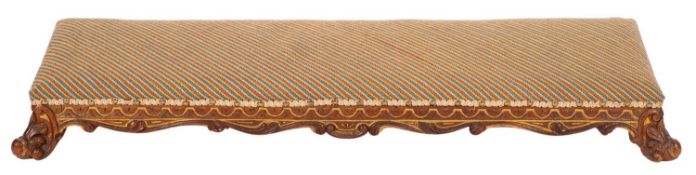 A Victorian carved walnut and partly gilt fender stool,