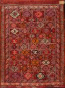 A pair of Balouchistan grain bags, the panelled faces with lozenge and hooked designs, 108cm x 79cm.