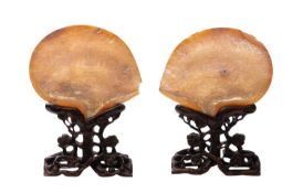 A pair of Chinese mother-of-pearl shells, late Qing dynasty each carved with a battle scene,