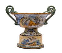 An Italian majolica urn and stand of oval form with scrolling handles decorated with mythological