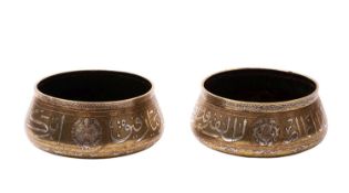 A pair of Mamluk Revival silver and copper inlaid brass basins,