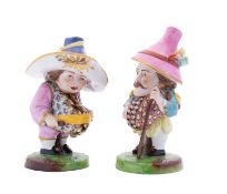 A pair of Continental figures of The Mansion House dwarves, early 20th century on mossy mound bases,