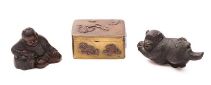 Three small pieces of Japanese metalwork comprising a bronzed metal figure of a monkey holding a