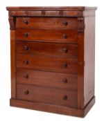 A Victorian mahogany Wellington Chest, the overhanging frieze with roundel ornament,