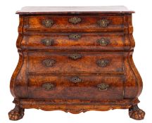 An 18th Century Dutch walnut bombe commode, the overhanging top of serpentine outline,