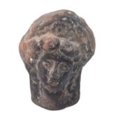 A moulded pottery model of the head of a woman, probably Hellenistic, late 4th / 3rd Century B.C.