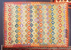 A Turkish kelim, the brightly coloured turquoise field with an all over design of stepped lozenges,