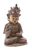 A Chinese gilt-bronze figure of Guanyin, 17th/18th century wearing an elaborate crown,