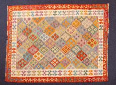 A Turkish kelim, the brightly coloured stepped lozenge field with stepped cruciform motifs,
