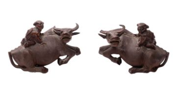 A pair of Chinese carved hardwood figures of water buffalo,