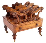 A Victorian carved rosewood three division canterbury, with moulded scroll palmette,