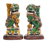 A pair of Chinese egg and spinach-glazed lion dog incense holders,