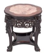 A Chinese hardwood urn table, of octofoil outline, the top inset with a panel of variegated marble,