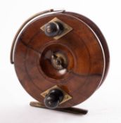 A 5 inch walnut and brass star back sea reel,
