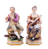 A pair of Derby figures of musicians, circa 1820 seated on gilded chairs, he playing a flute,