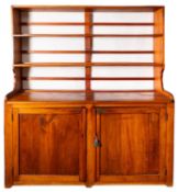 A South African yellow-wood dresser, early 20th Century, with plate rack above twin panel door.