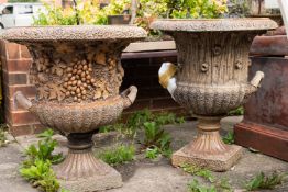 Two similar salt glazed stoneware twin handled garden urns, by Hexter Humpherson & Co.