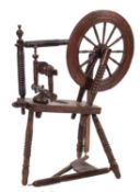 A 19th Century pine and fruitwood spinning wheel,