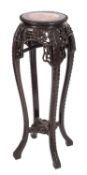 A Chinese carved hardwood circular jardiniere stand, the top with a gadrooned edge,