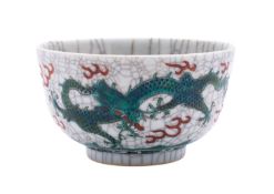 A Chinese crackle-glazed 'Dragon' bowl enamelled in green and iron-red with dragons chasing